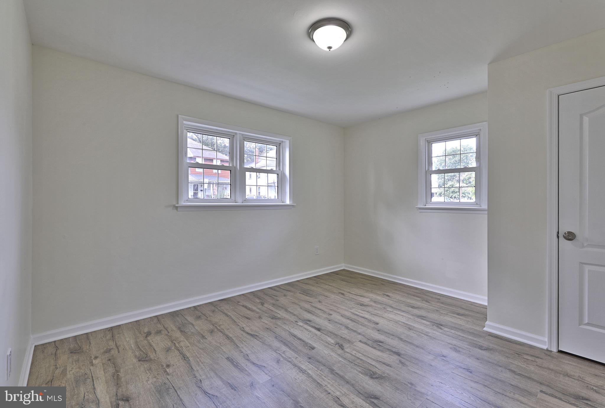 620 Arndt Avenue Riverside, NJ 08075 - Photo 19 of 22 an empty room with wooden floor and windows