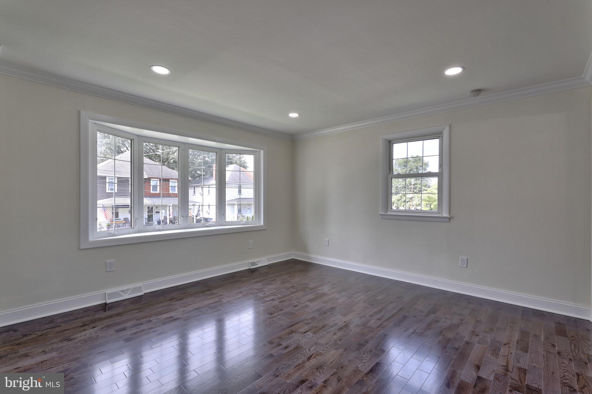 620 Arndt Avenue Riverside, NJ 08075 - Photo 5 of 22 a view of an empty room with wooden floor and a window