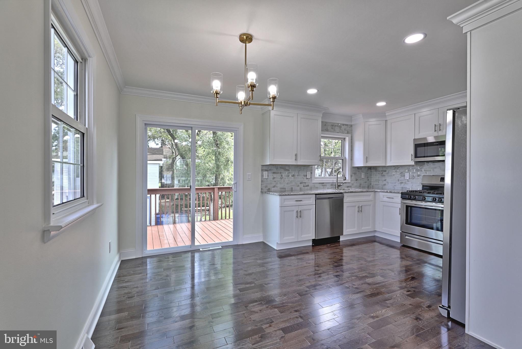620 Arndt Avenue Riverside, NJ 08075 - Photo 7 of 22 a large kitchen with granite countertop a large counter top space a stove a refrigerator cabinets and living room view