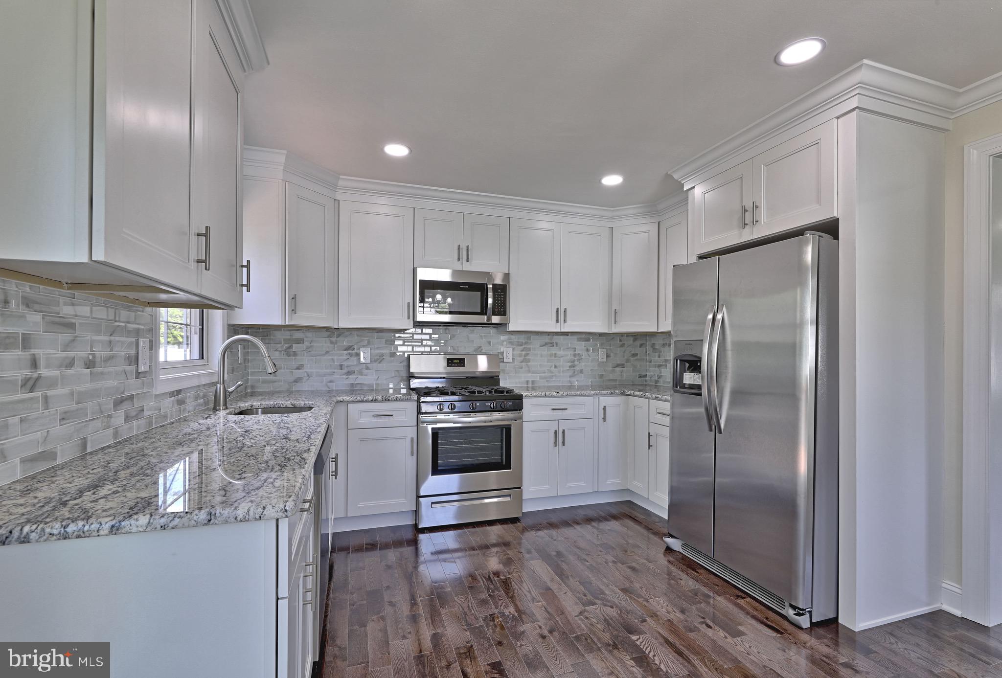 620 Arndt Avenue Riverside, NJ 08075 - Photo 9 of 22 a kitchen with stainless steel appliances granite countertop a refrigerator a stove and a sink