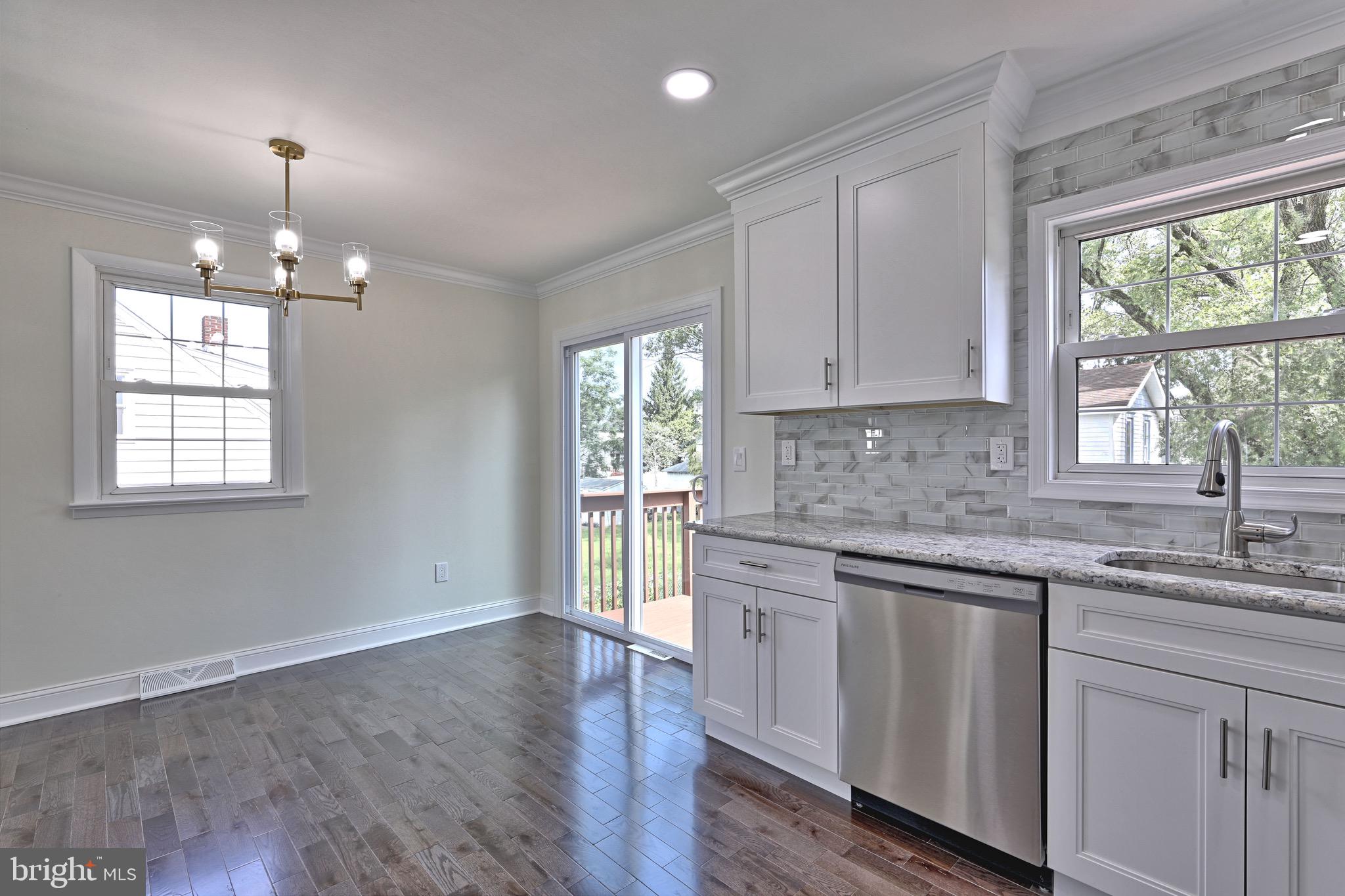 620 Arndt Avenue Riverside, NJ 08075 - Photo 10 of 22 a kitchen with kitchen island granite countertop a stove a sink and windows