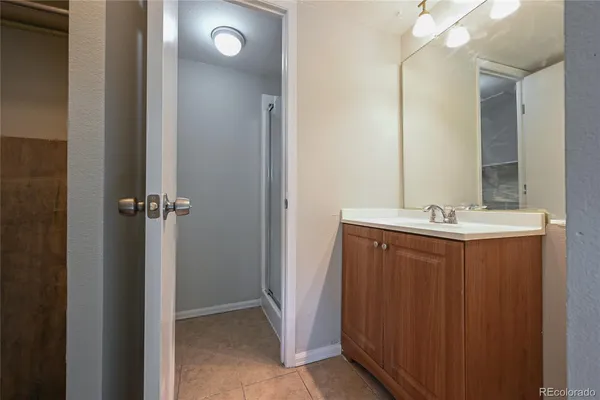a bathroom with a sink vanity and a mirror