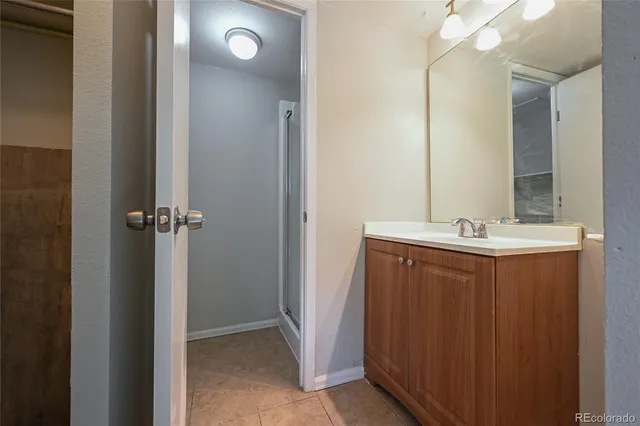 a bathroom with a sink vanity and a mirror