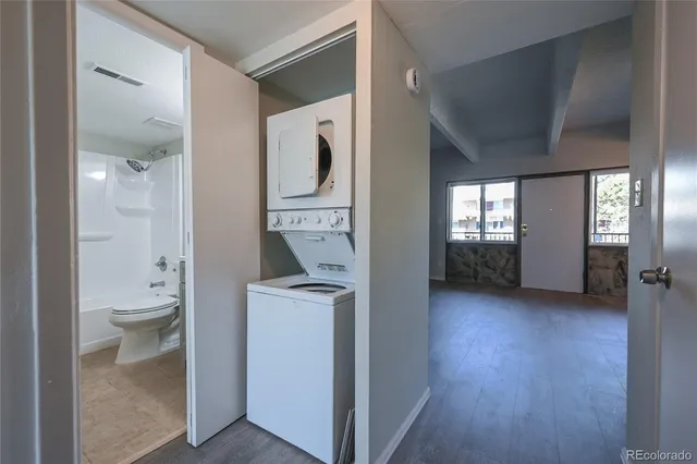 a view of a bathroom with toilet and windows