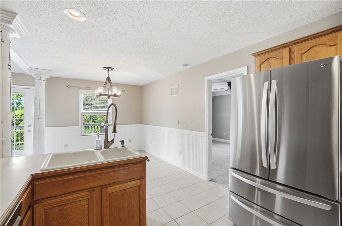 1208 Jarva Lane Springboro, OH 45066 - Photo 27 of 75 This bright kitchen features a double sink and stainless steel appliances, seamlessly connecting to other living areas.