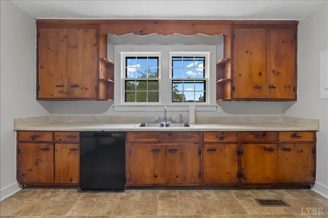 a kitchen with stainless steel appliances granite countertop a sink and cabinets with wooden floor