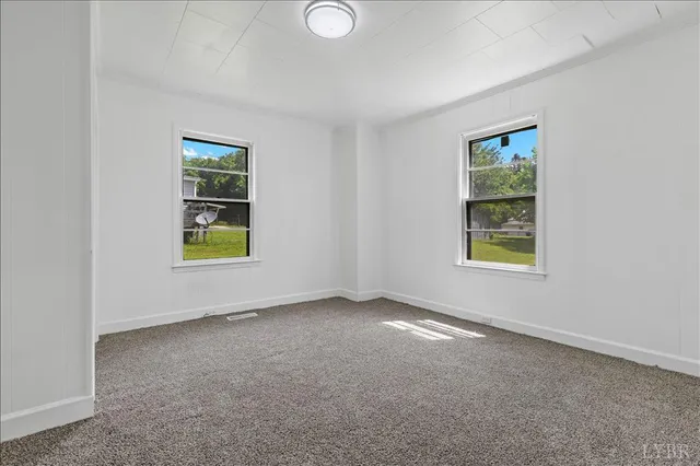 an empty room with windows and entrance