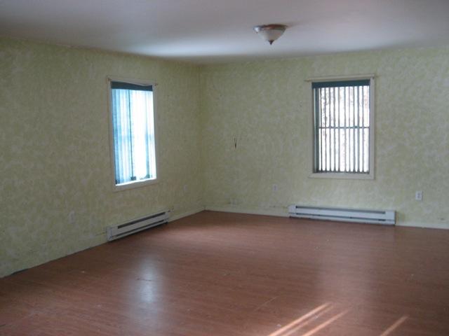 513 Polikoff Road Sheffield, MA 01222 - Photo 8 of 9 an empty room with wooden floor and windows