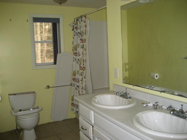 513 Polikoff Road Sheffield, MA 01222 - Photo 9 of 9 a bathroom with a granite countertop sink toilet and a mirror