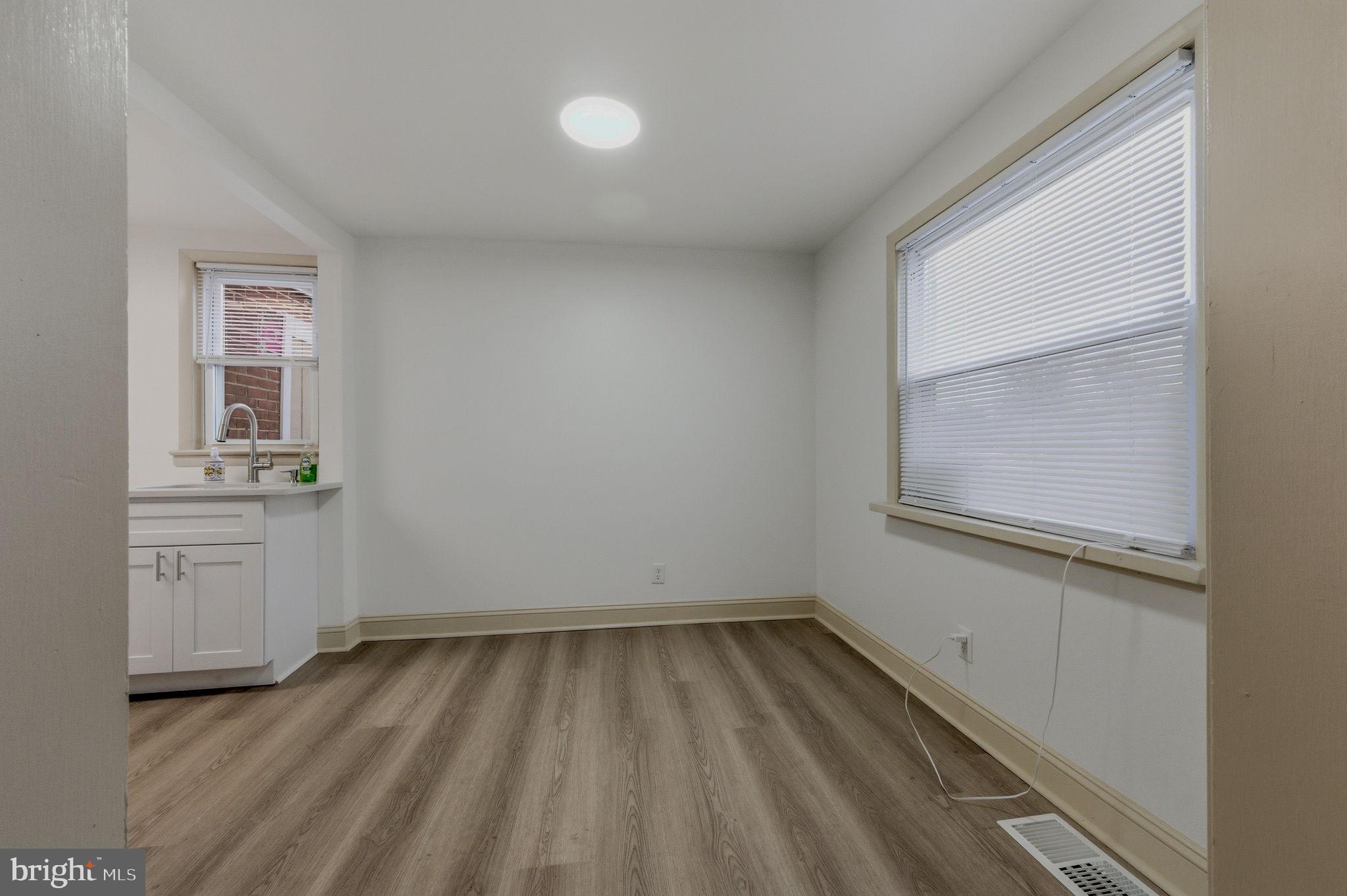 208 Harding Avenue Wilmington, DE 19804 - Photo 14 of 28 a view of a kitchen with wooden floor and a window