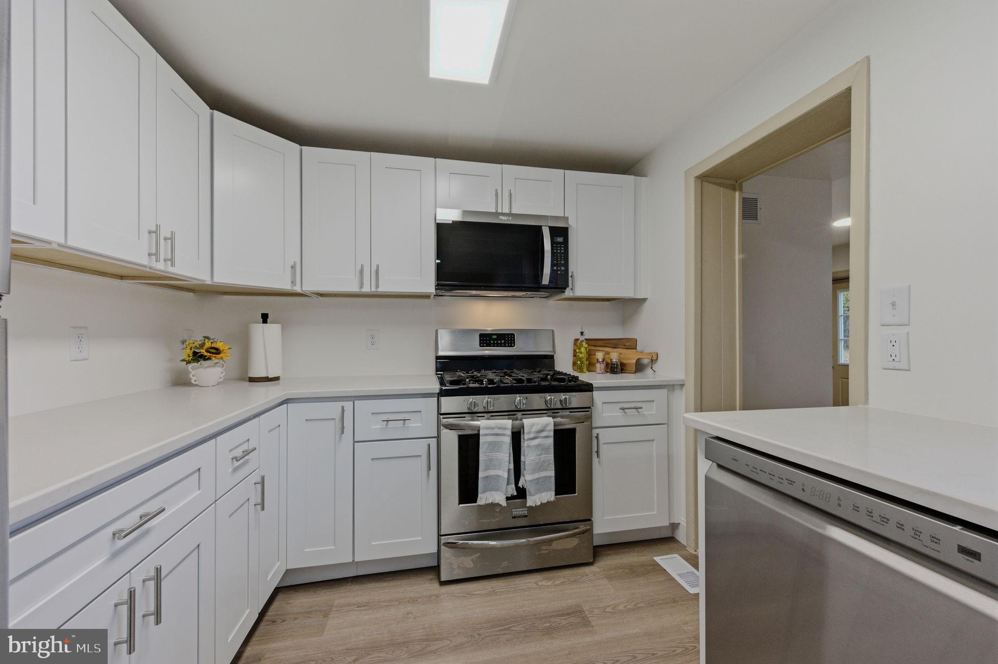 208 Harding Avenue Wilmington, DE 19804 - Photo 17 of 28 a kitchen with white cabinets and stainless steel appliances