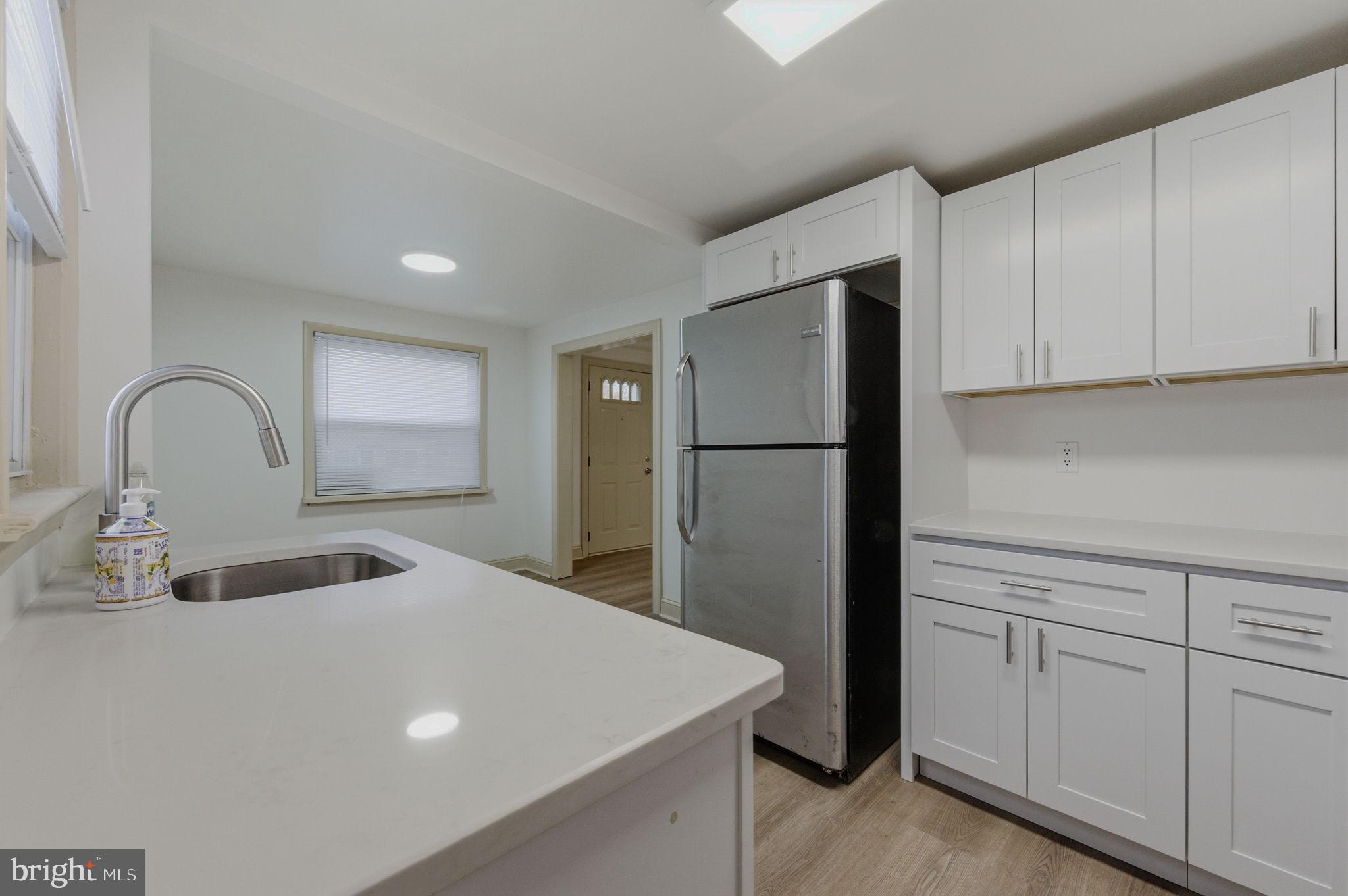208 Harding Avenue Wilmington, DE 19804 - Photo 18 of 28 a kitchen with a refrigerator and a sink