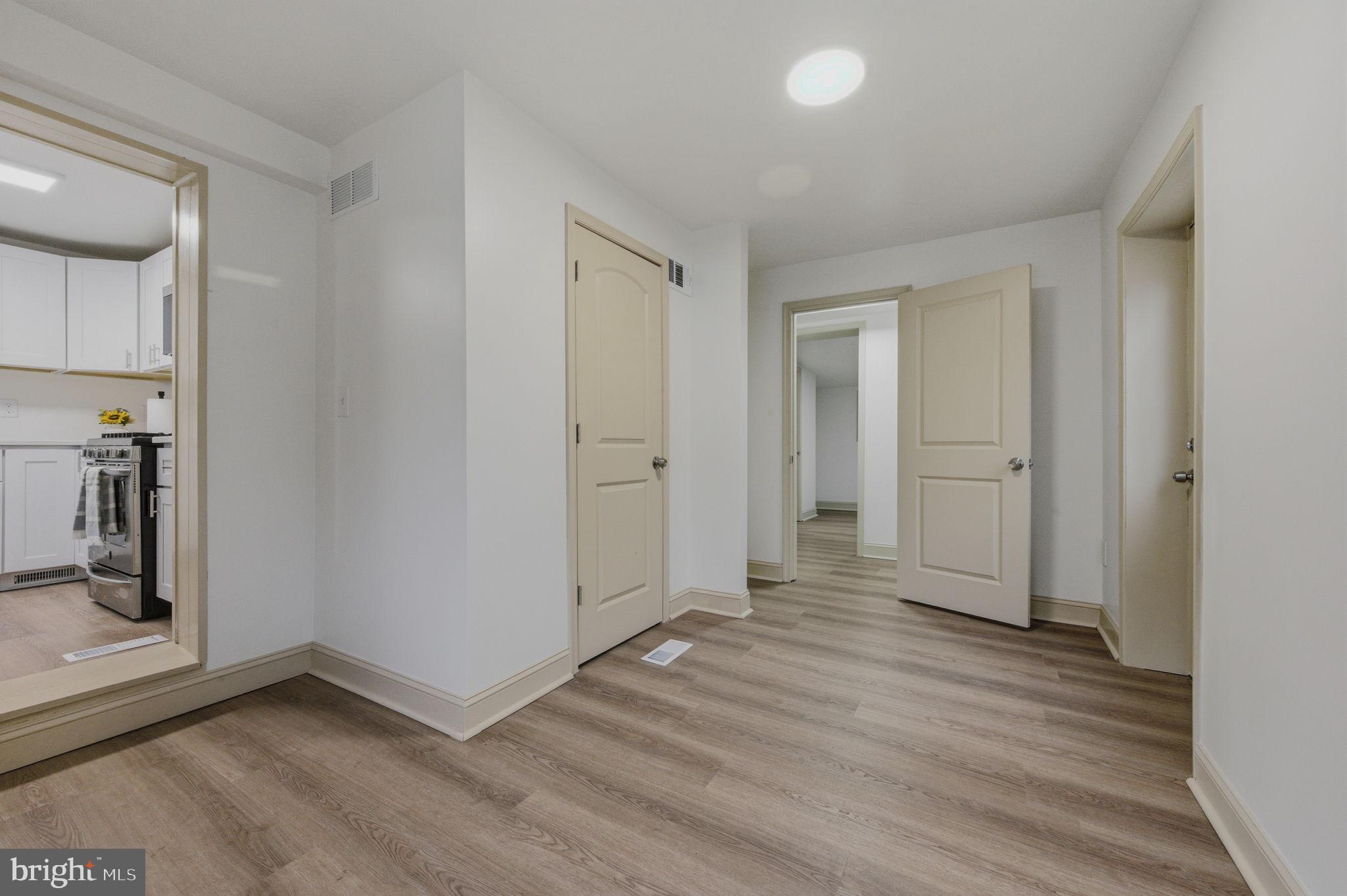 208 Harding Avenue Wilmington, DE 19804 - Photo 19 of 28 an empty room with wooden floor and a fireplace