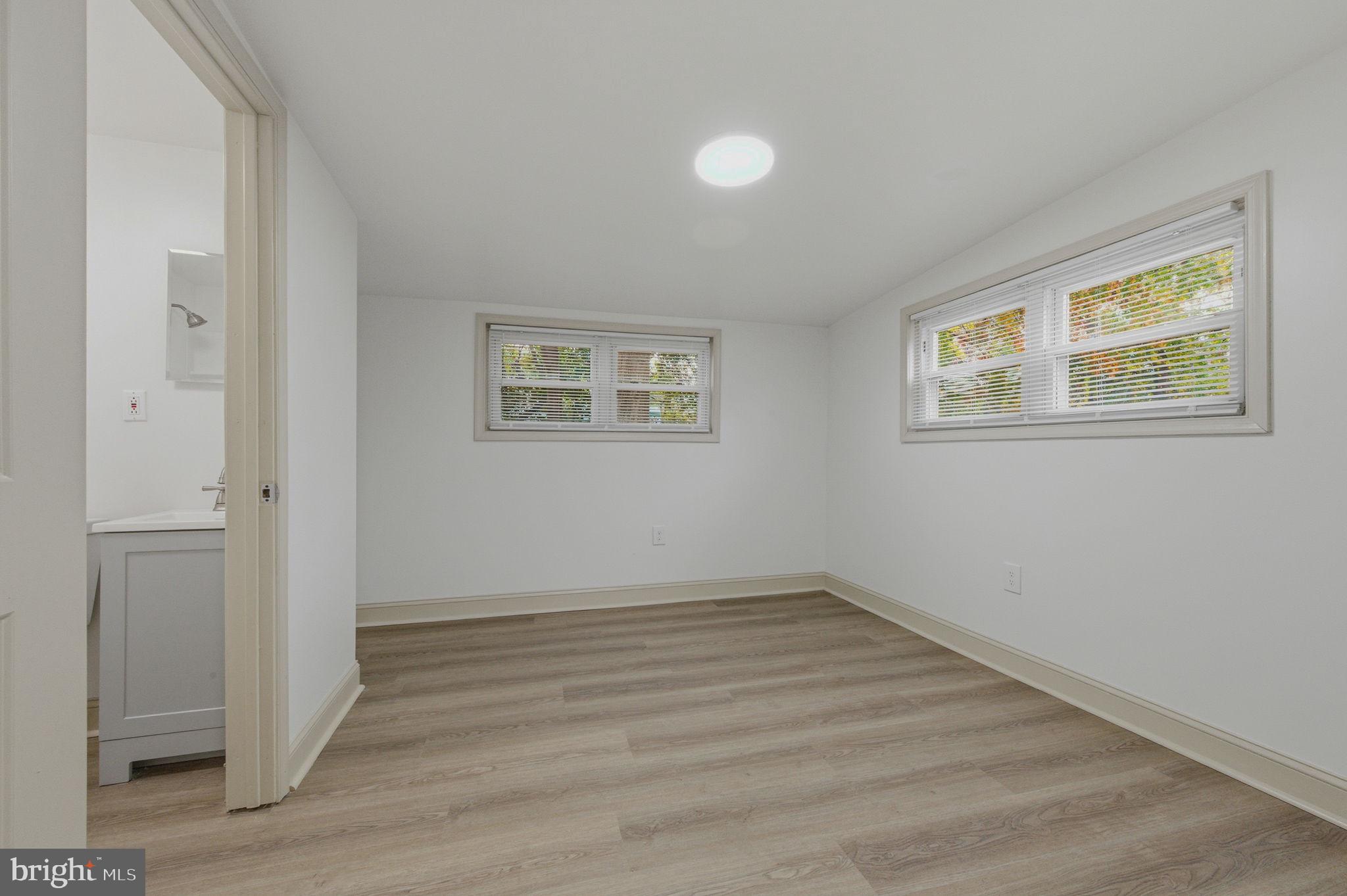 208 Harding Avenue Wilmington, DE 19804 - Photo 21 of 28 a view of an empty room with wooden floor and a window