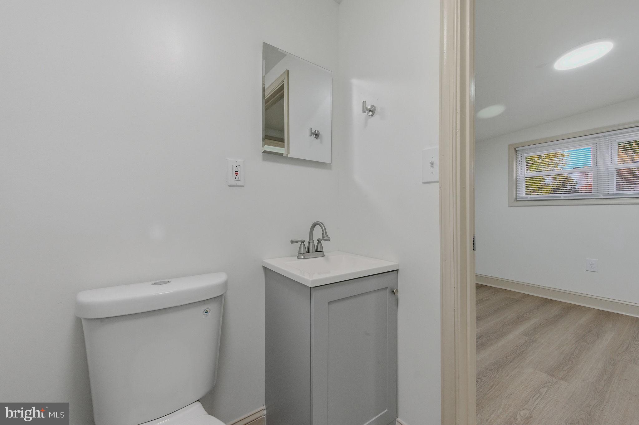 208 Harding Avenue Wilmington, DE 19804 - Photo 23 of 28 a bathroom with a sink a toilet and mirror