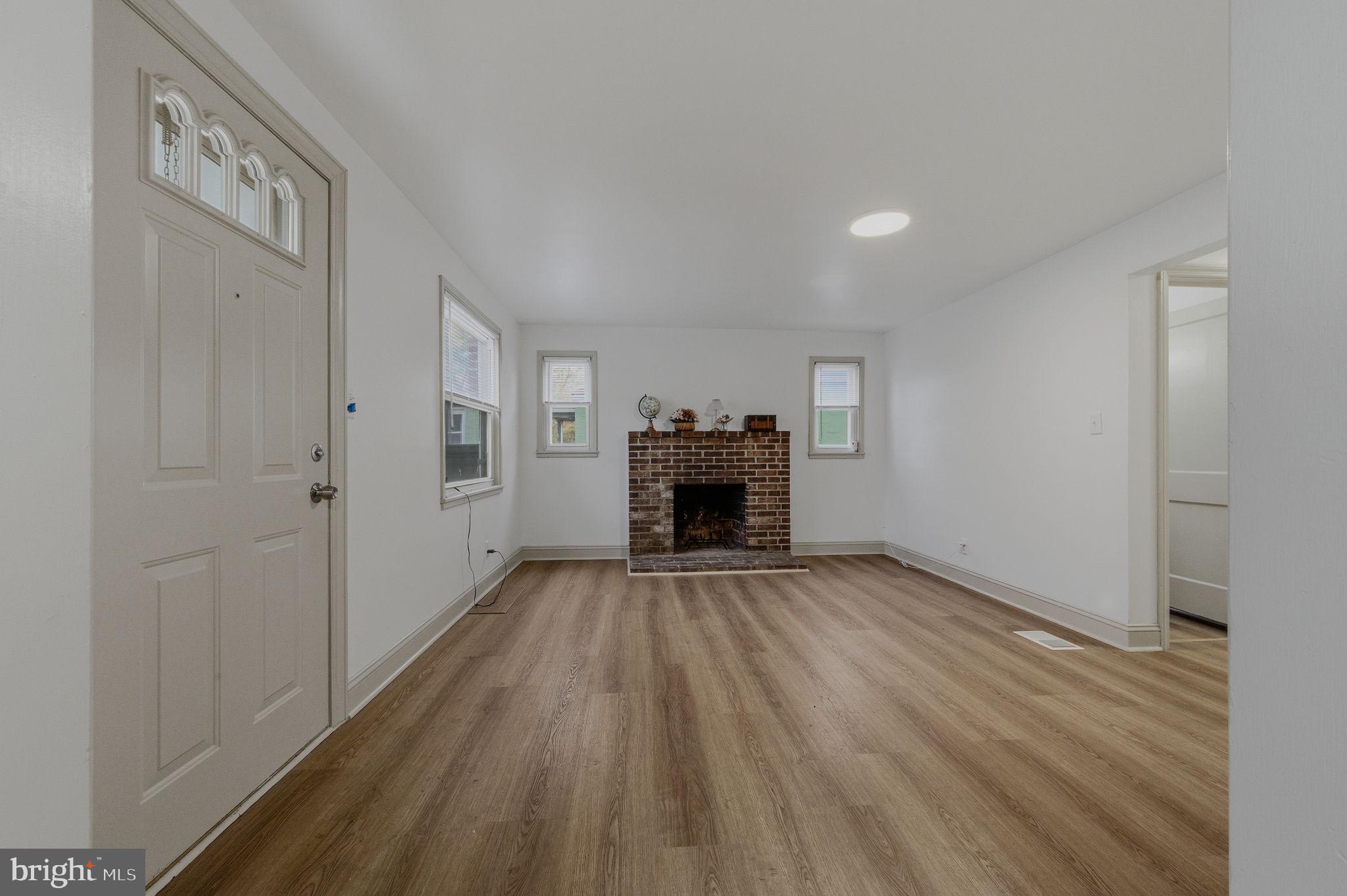 208 Harding Avenue Wilmington, DE 19804 - Photo 4 of 28 a view of empty room with fireplace and wooden floor