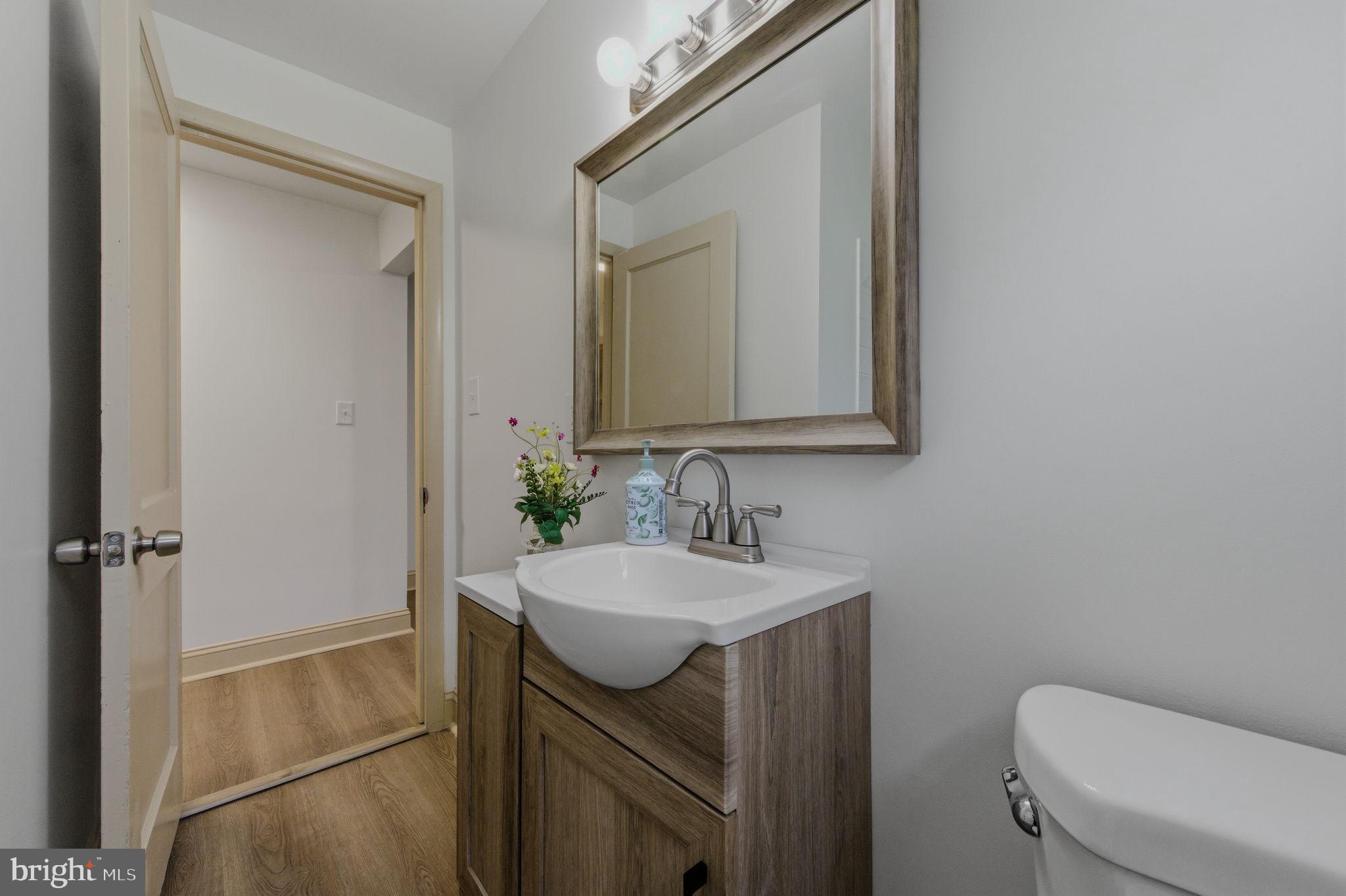 208 Harding Avenue Wilmington, DE 19804 - Photo 8 of 28 a bathroom with a toilet sink and mirror