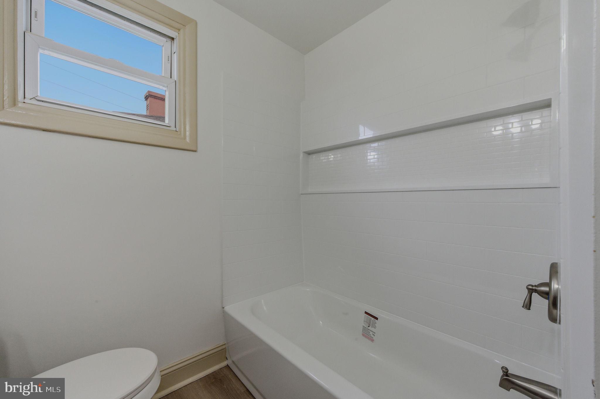 208 Harding Avenue Wilmington, DE 19804 - Photo 9 of 28 a white bath tub sitting next to a toilet
