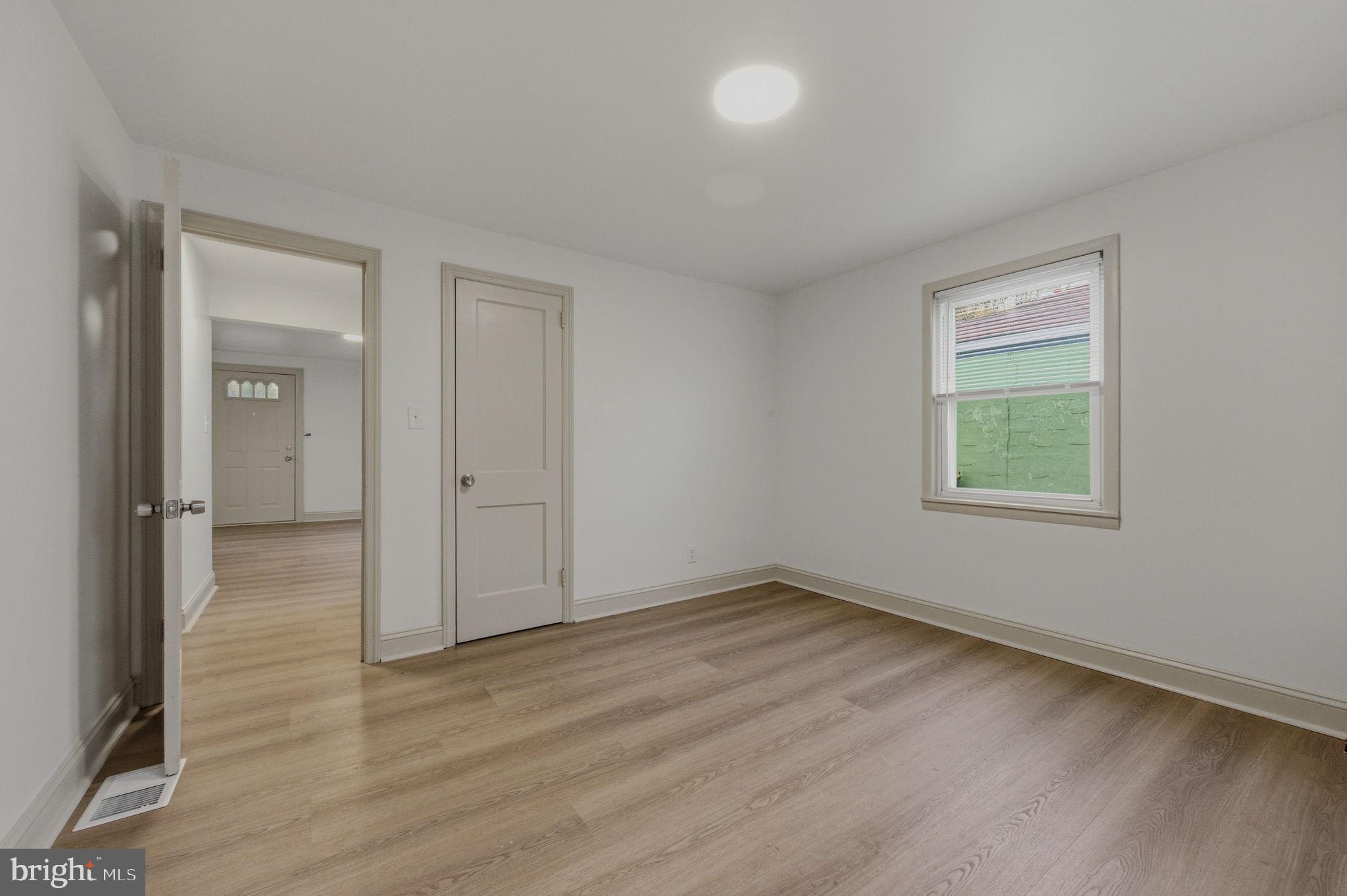 208 Harding Avenue Wilmington, DE 19804 - Photo 10 of 28 a view of an empty room with wooden floor and a window