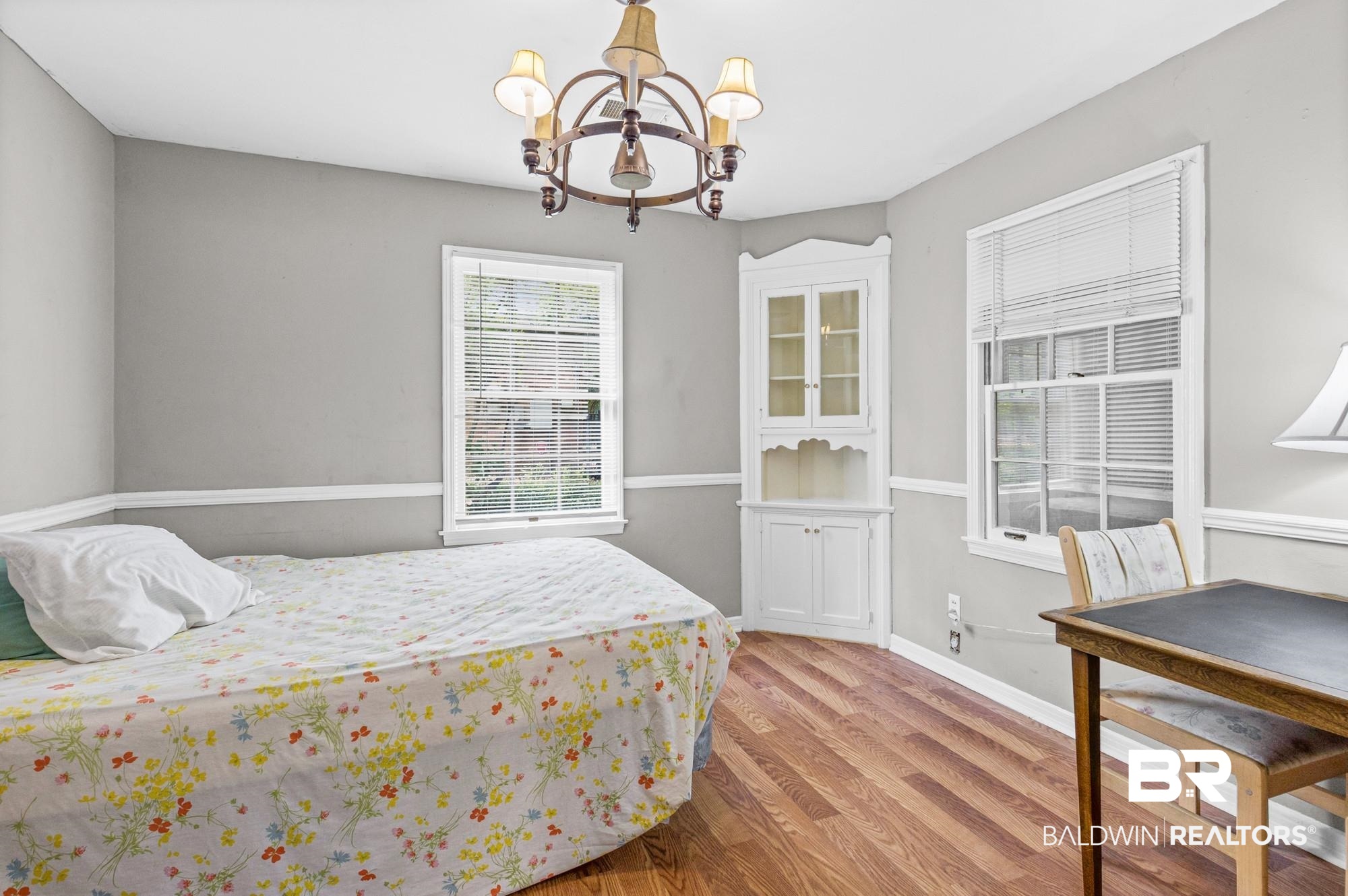 5510 Richmond Road Mobile, AL 36608 - Photo 13 of 21 Interior room featuring wood-finish flooring, light gray wall paint, and white chair rail molding