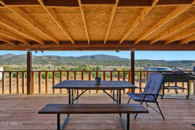 a roof deck with a table and chairs