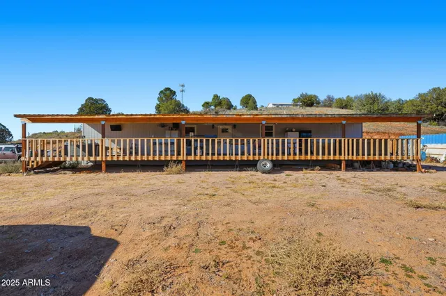 a view of a yard with wooden fence