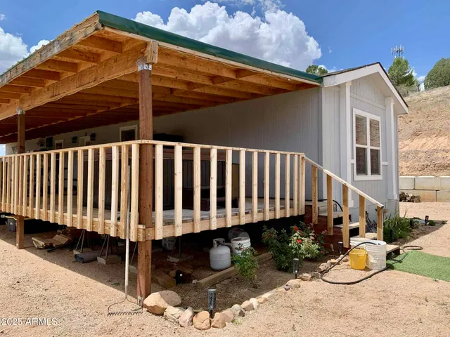 a view of a small deck and a yard