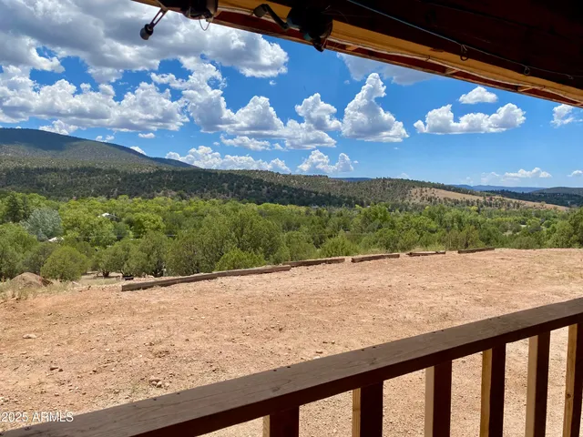 a view of a yard with wooden fence