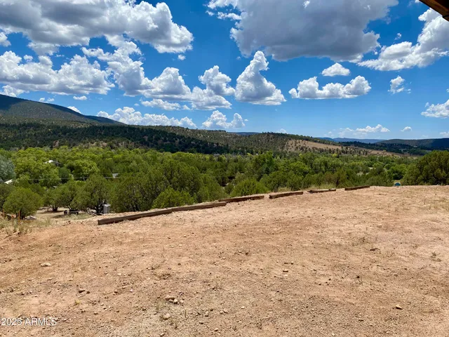 a view of a patio with dining table and chairs with a yard