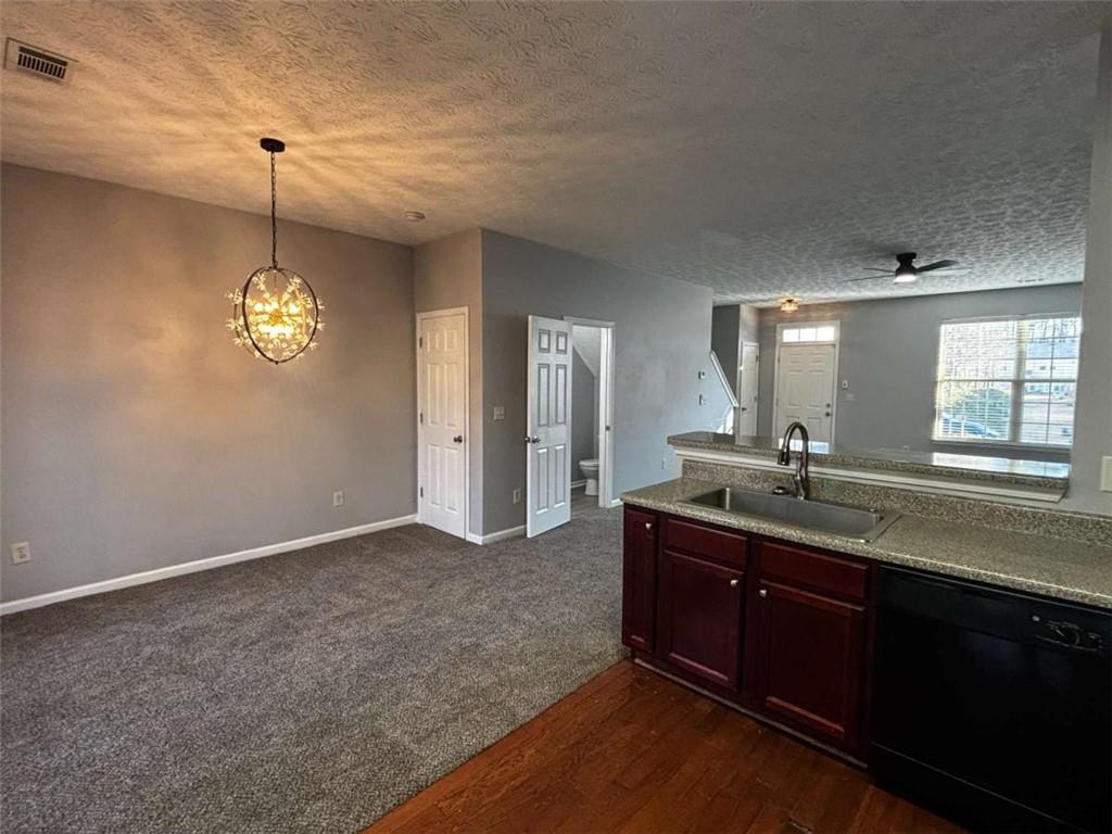 4249 High Park Lane East Point, GA 30344 - Photo 11 of 27 a kitchen with kitchen island granite countertop stainless steel appliances a sink cabinets and window