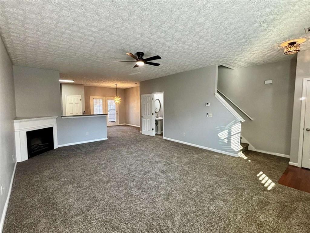 4249 High Park Lane East Point, GA 30344 - Photo 4 of 27 an empty room with windows and fireplace