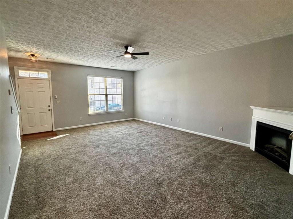 4249 High Park Lane East Point, GA 30344 - Photo 5 of 27 an empty room with windows and fireplace
