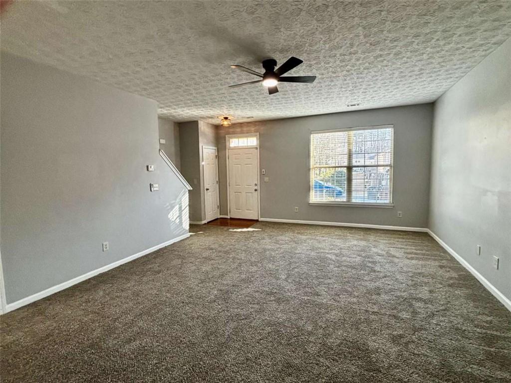 4249 High Park Lane East Point, GA 30344 - Photo 6 of 27 an empty room with a ceiling fan and window