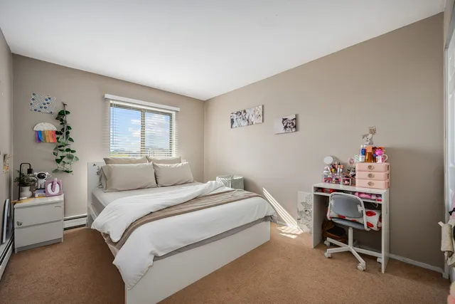 a bedroom with a bed and a desk