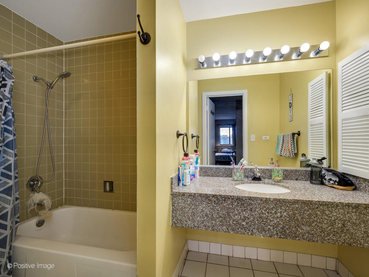 1931 Prairie Square, Unit 311 Schaumburg, IL 60173 - Photo 14 of 20 a bathroom with a granite countertop sink a large mirror and a bathtub