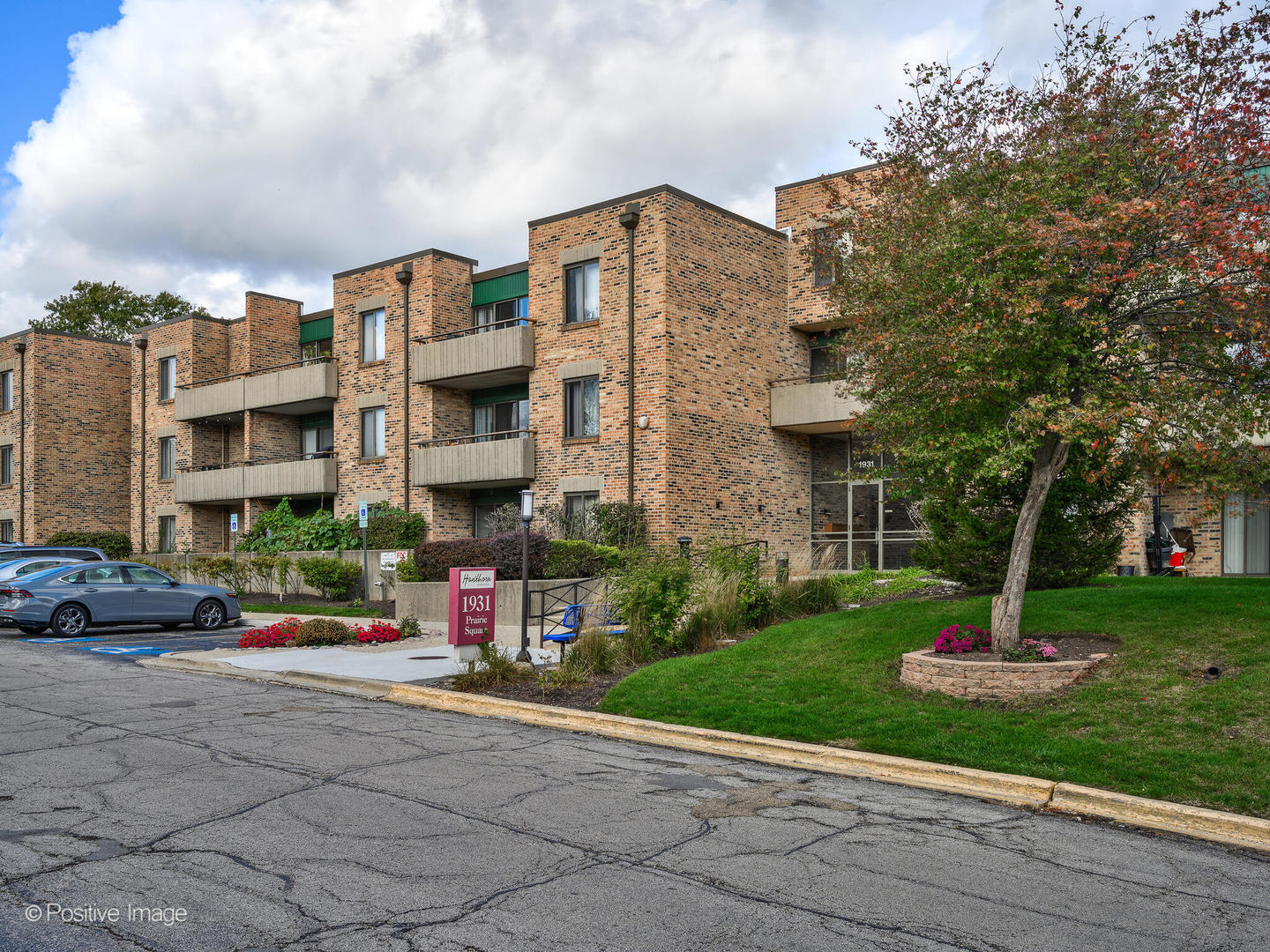 1931 Prairie Square, Unit 311 Schaumburg, IL 60173 - Photo 2 of 20 a front view of a building with garden and trees