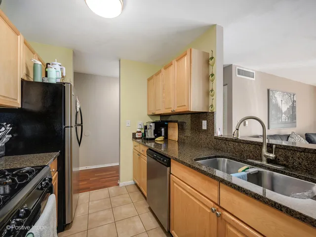 a kitchen with a sink stove and refrigerator