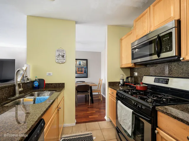a kitchen with stainless steel appliances a stove a sink and a microwave