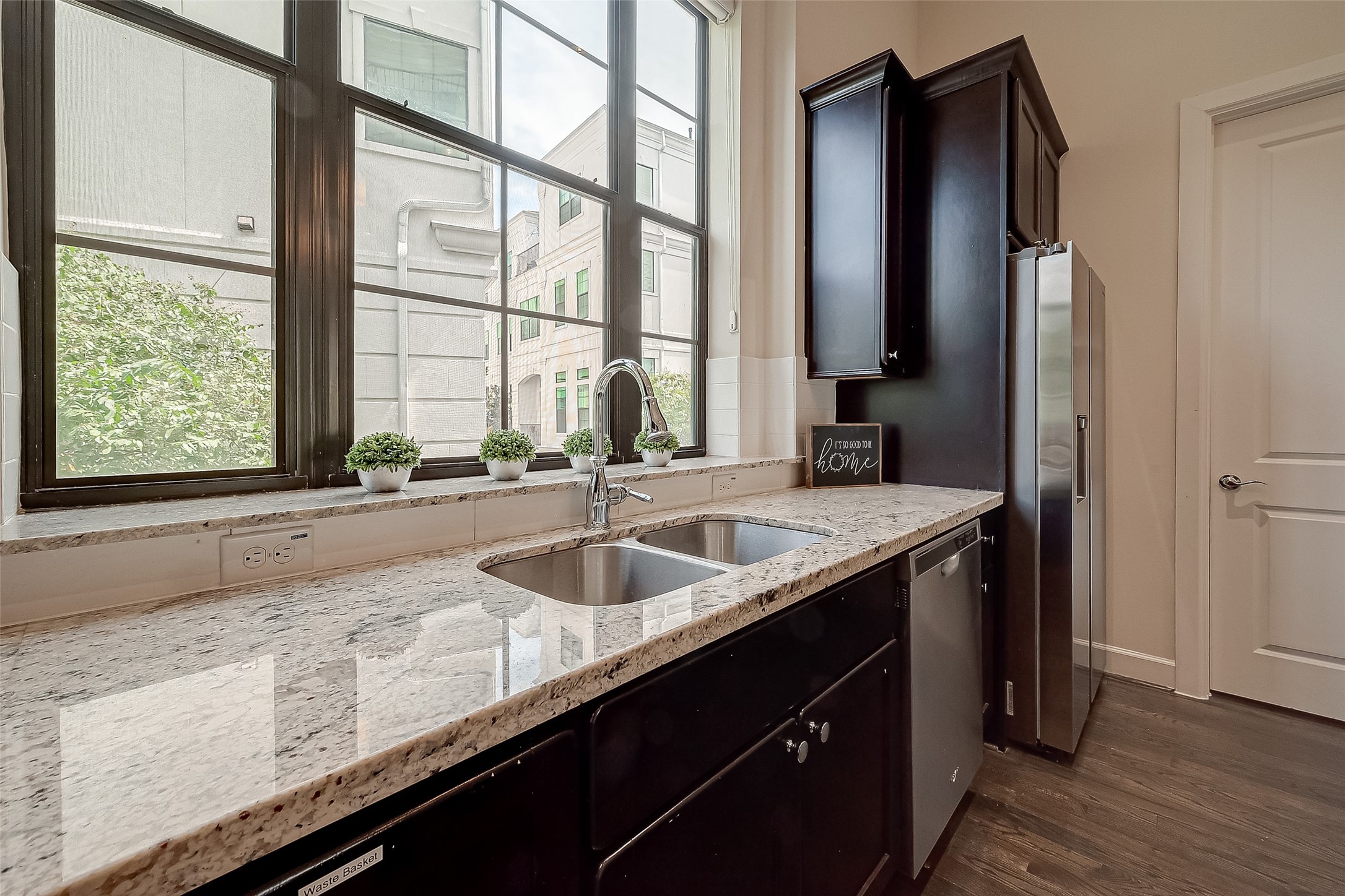 5305 Weslayan Street Houston, TX 77005 - Photo 15 of 50 a kitchen with granite countertop a sink and a large window