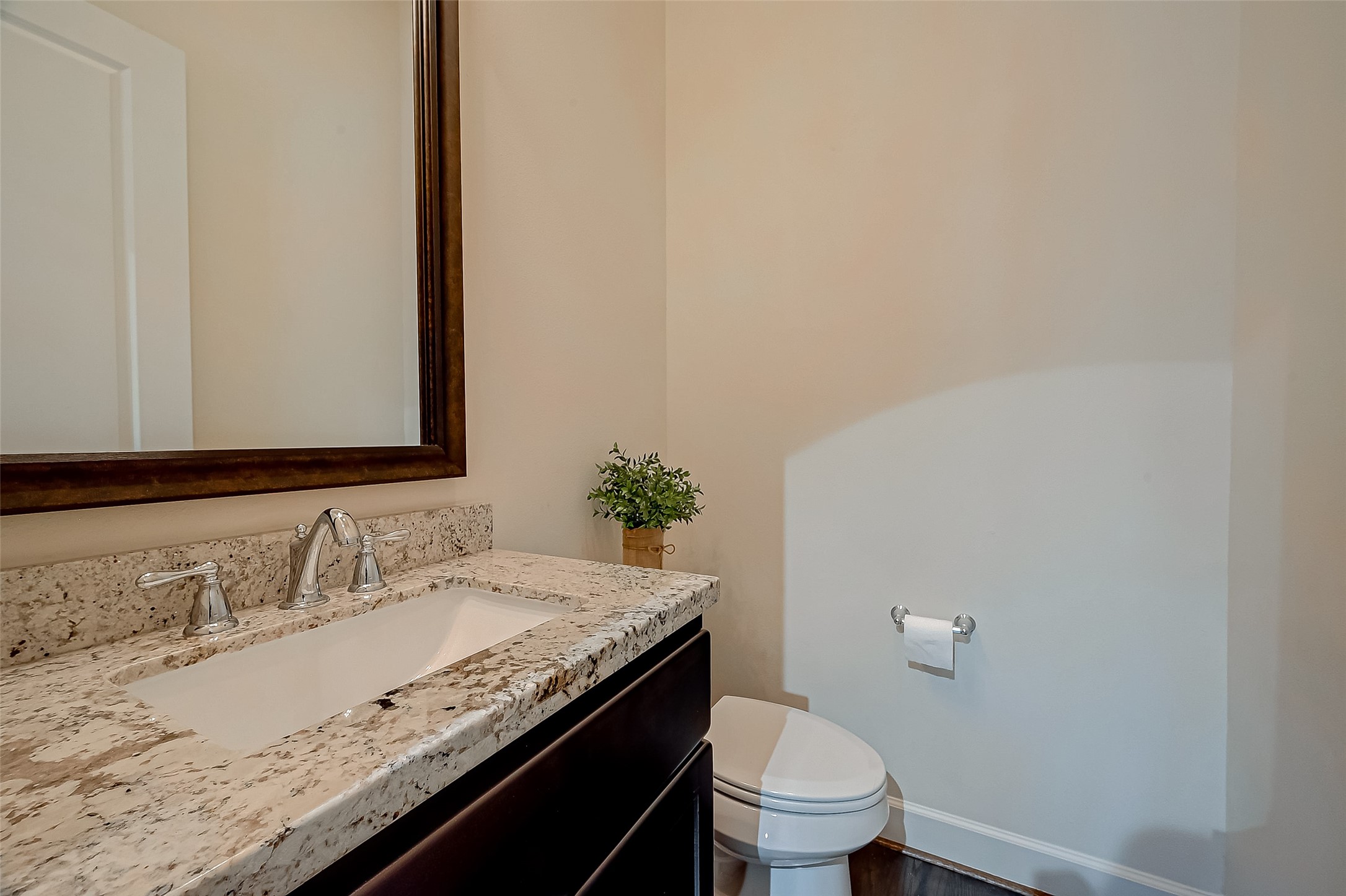 5305 Weslayan Street Houston, TX 77005 - Photo 19 of 50 a bathroom with a granite countertop sink a toilet and a mirror