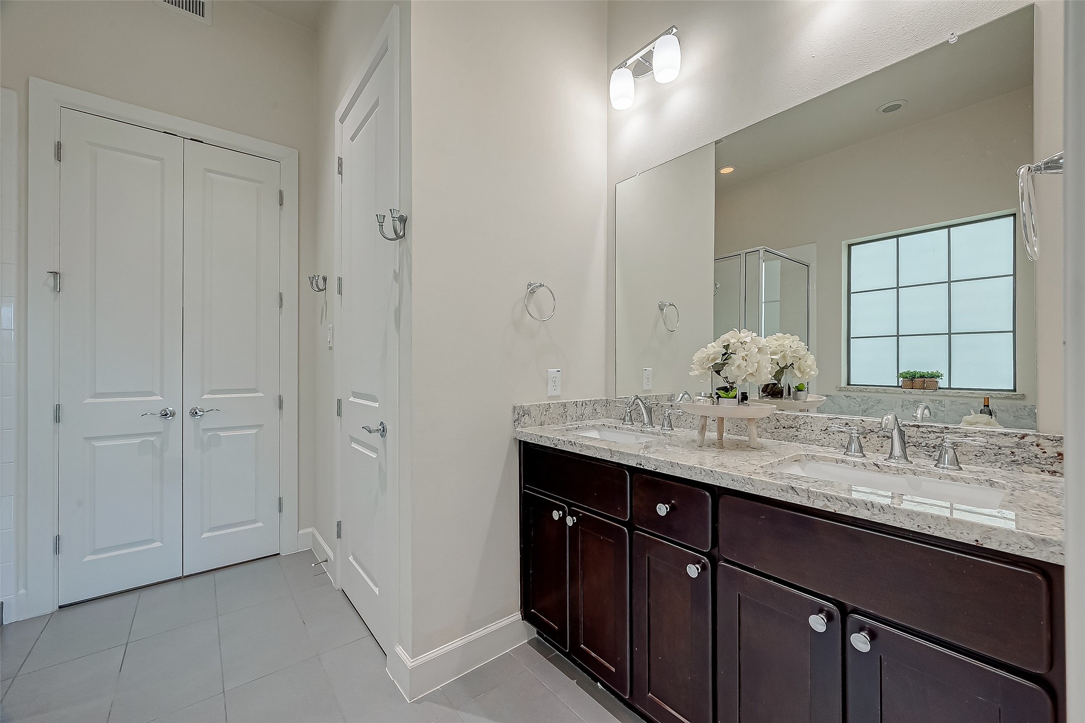 5305 Weslayan Street Houston, TX 77005 - Photo 25 of 50 a bathroom with a granite countertop sink and a mirror