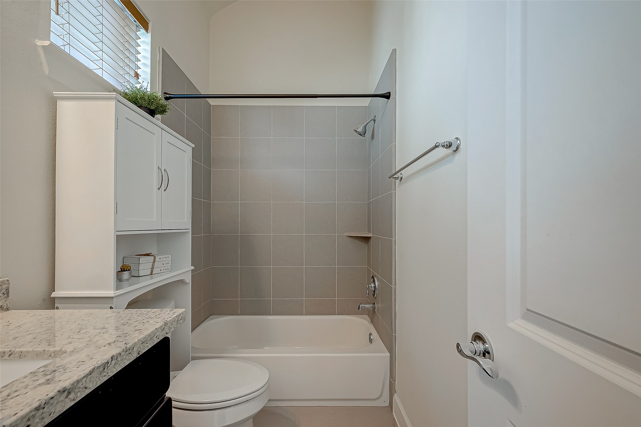 5305 Weslayan Street Houston, TX 77005 - Photo 30 of 50 a bathroom with a granite countertop bathtub shower sink vanity and toilet