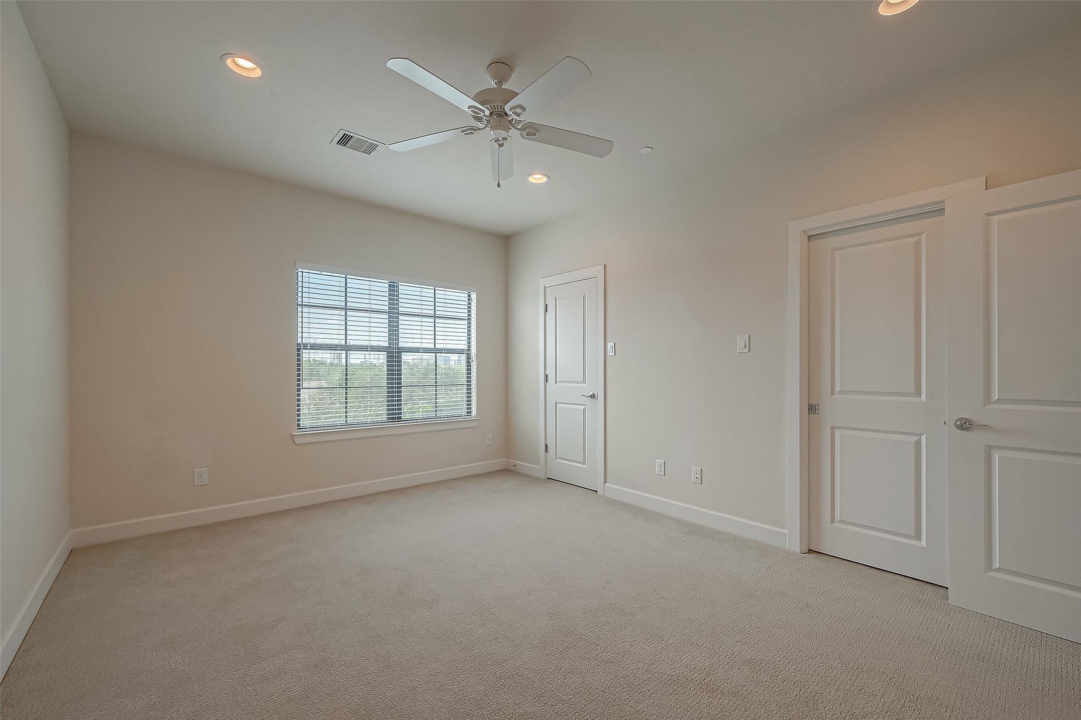 5305 Weslayan Street Houston, TX 77005 - Photo 36 of 50 an empty room with chandelier fan and windows