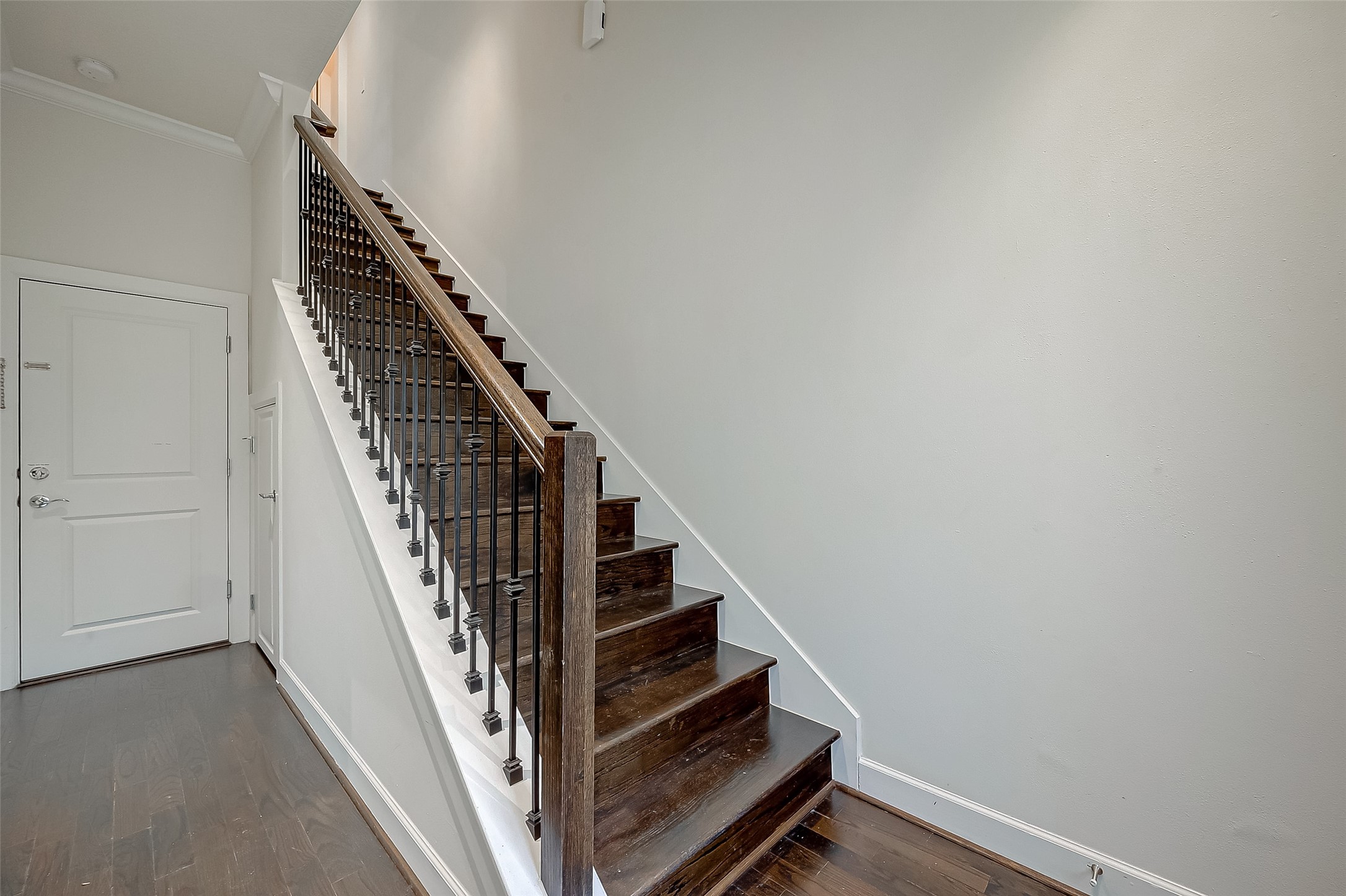 5305 Weslayan Street Houston, TX 77005 - Photo 5 of 50 a view of staircase with wooden floor and white walls