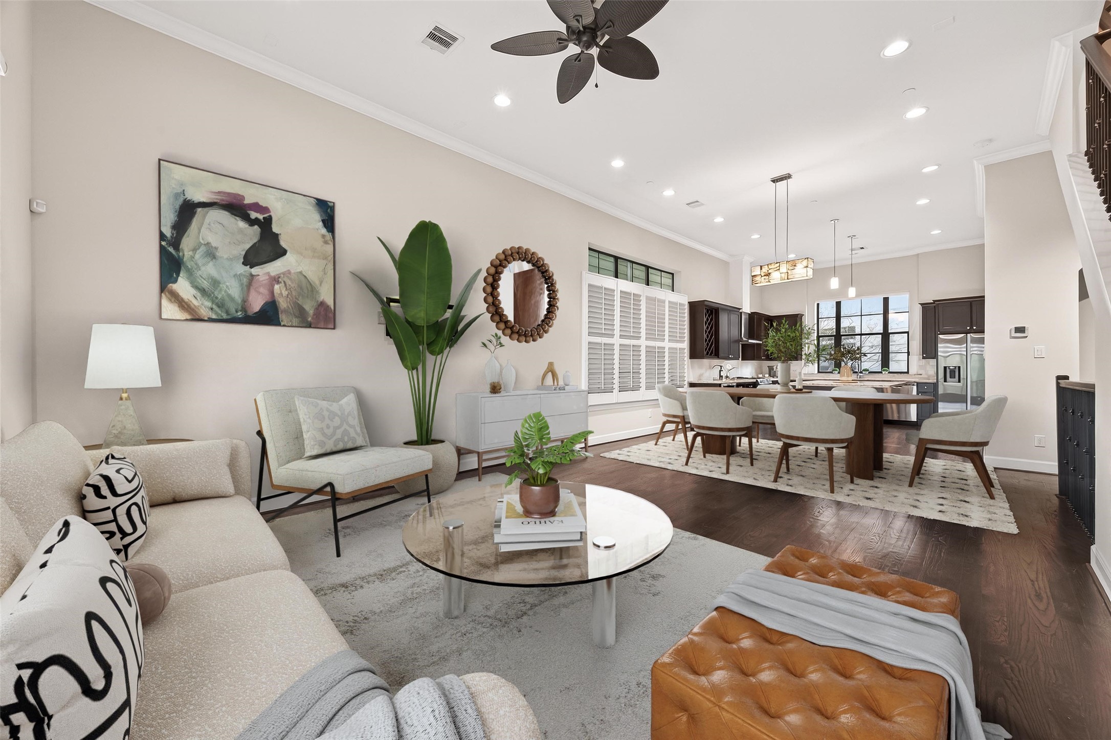 5305 Weslayan Street Houston, TX 77005 - Photo 9 of 50 This spacious, open-concept living area features elegant hardwood floors and abundant natural light. The modern kitchen with a large island seamlessly integrates into the dining and living spaces, ideal for entertaining.