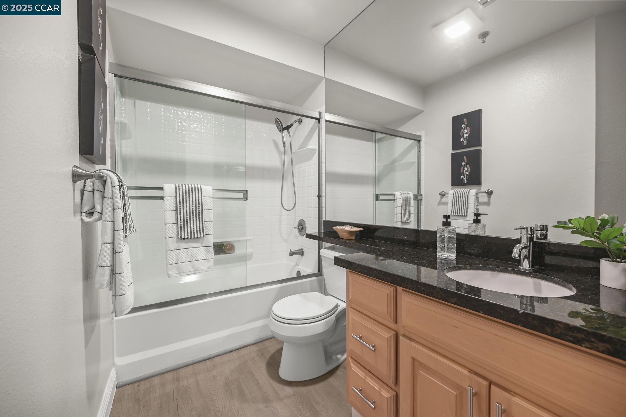 2550 Oak Road, Unit 209 Walnut Creek, CA 94597 - Photo 21 of 34 a bathroom with a granite countertop sink toilet and shower