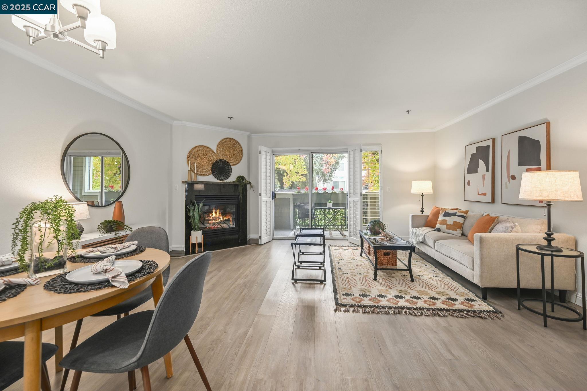 2550 Oak Road, Unit 209 Walnut Creek, CA 94597 - Photo 3 of 34 a living room with furniture a fireplace a rug and a large window