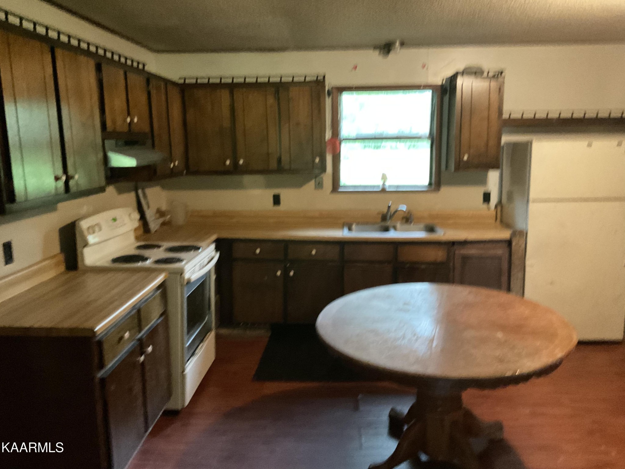 1901 Muddy Creek Road Spring City, TN 37381 - Photo 8 of 11 a kitchen with a sink a stove a window cabinets and stainless steel appliances