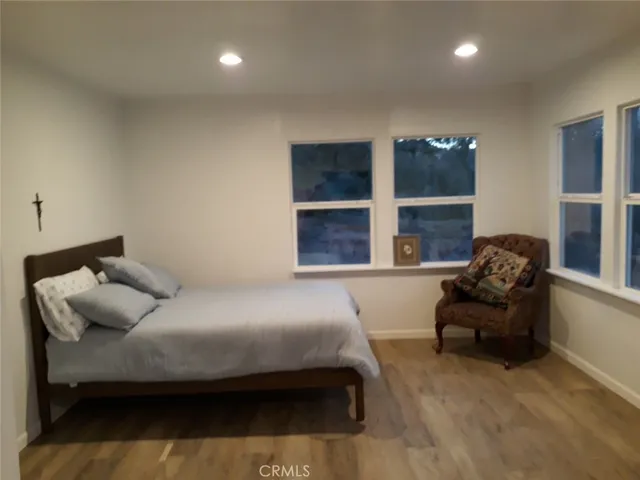 a bedroom with a bed and glass window