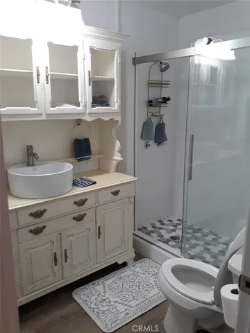a bathroom with a sink a toilet and shower
